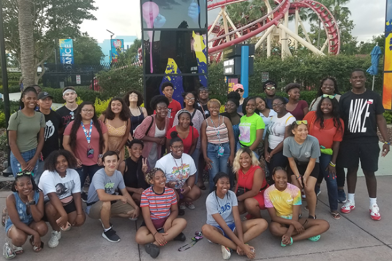 Group of students at amusement park with upward bound
